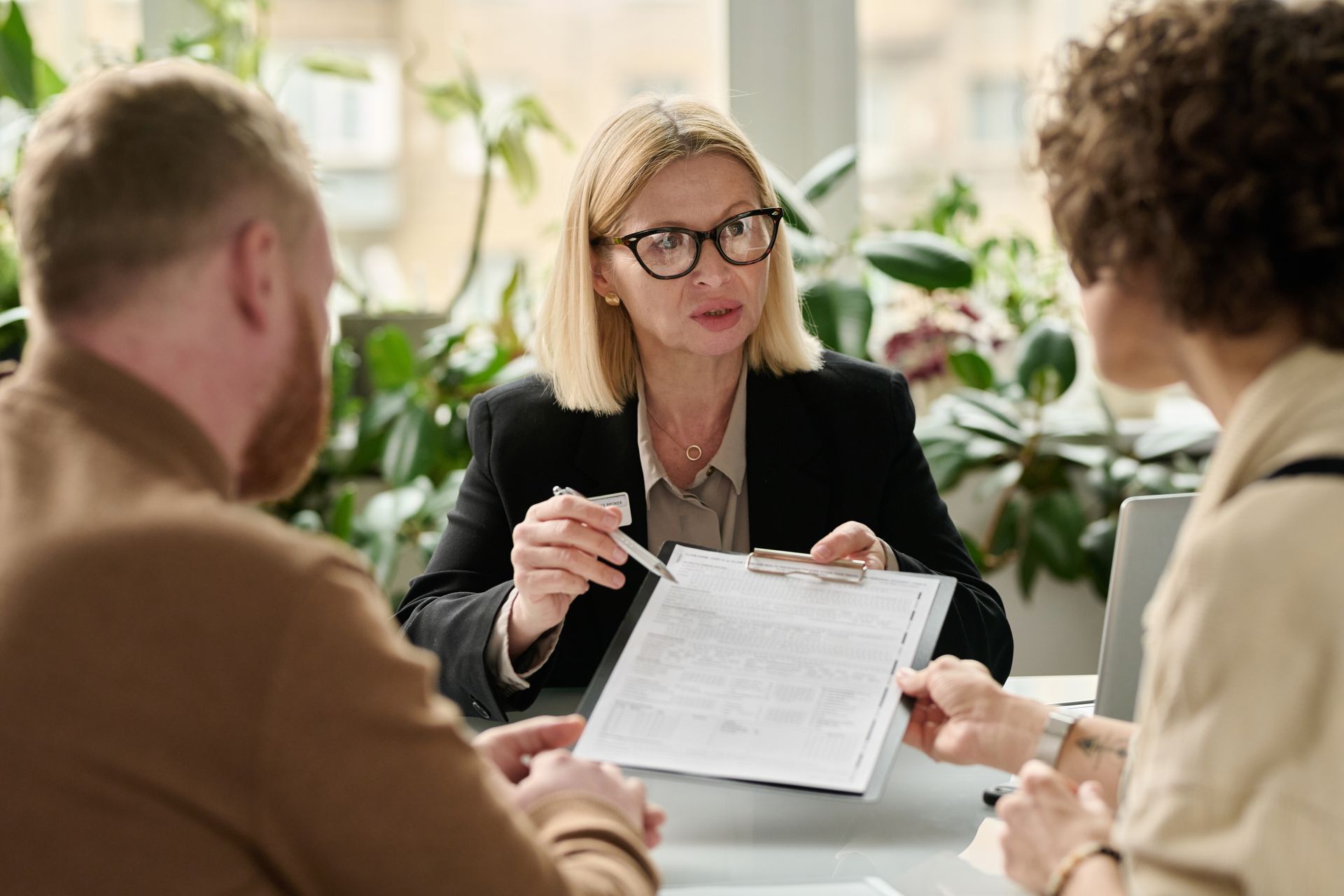 An attorney is reviewing documents with clients at a consultation.
