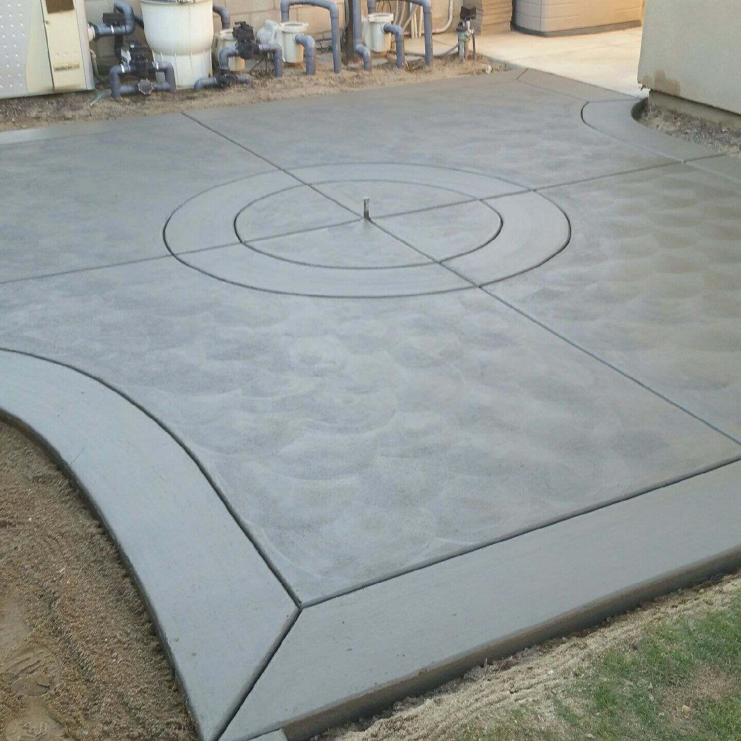 A concrete patio with a circle in the middle