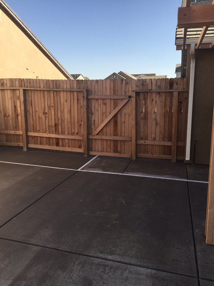 A wooden fence with a gate in the middle of it