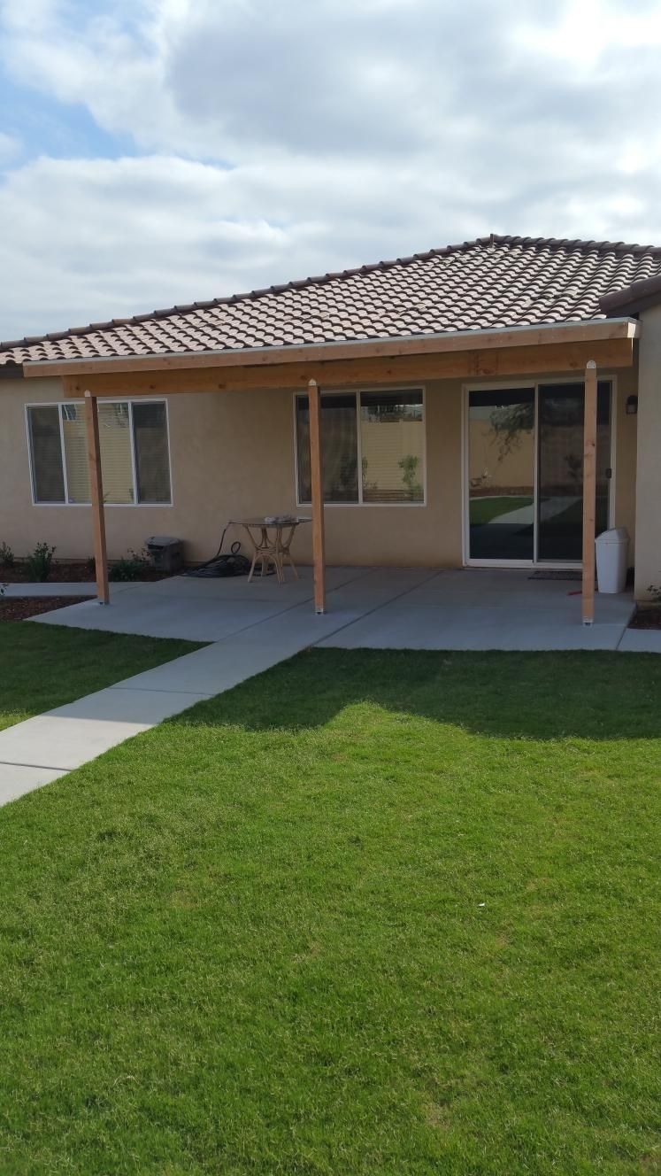 A house with a covered porch and sliding glass doors