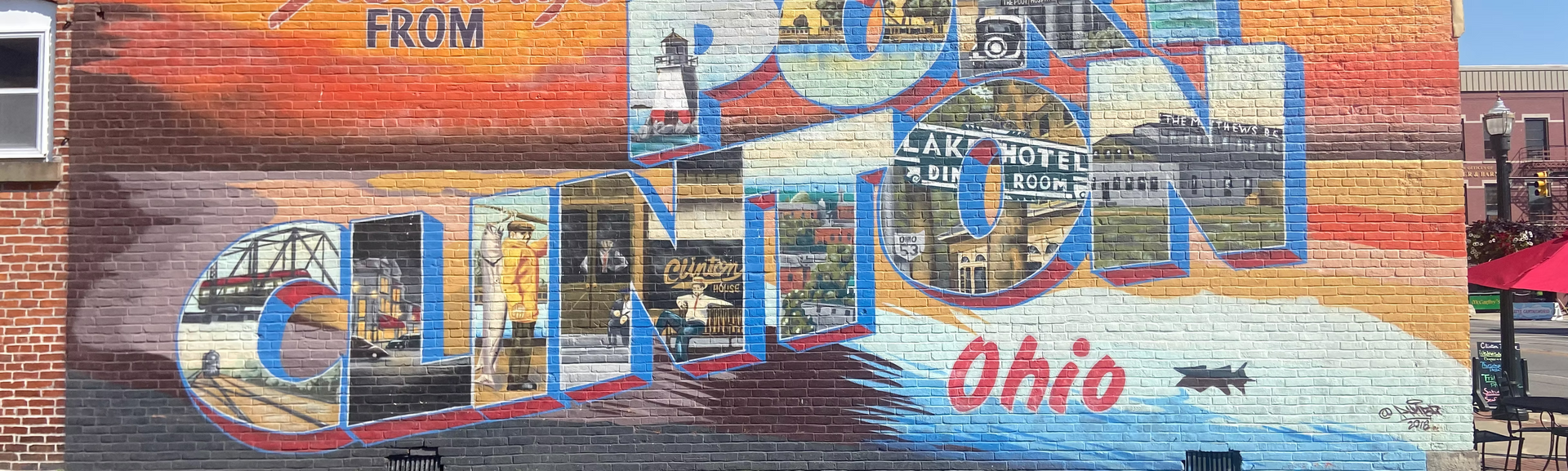 Colorful mural with the word “Ohio” and a painted skyline, featuring a large blue “C” shape.