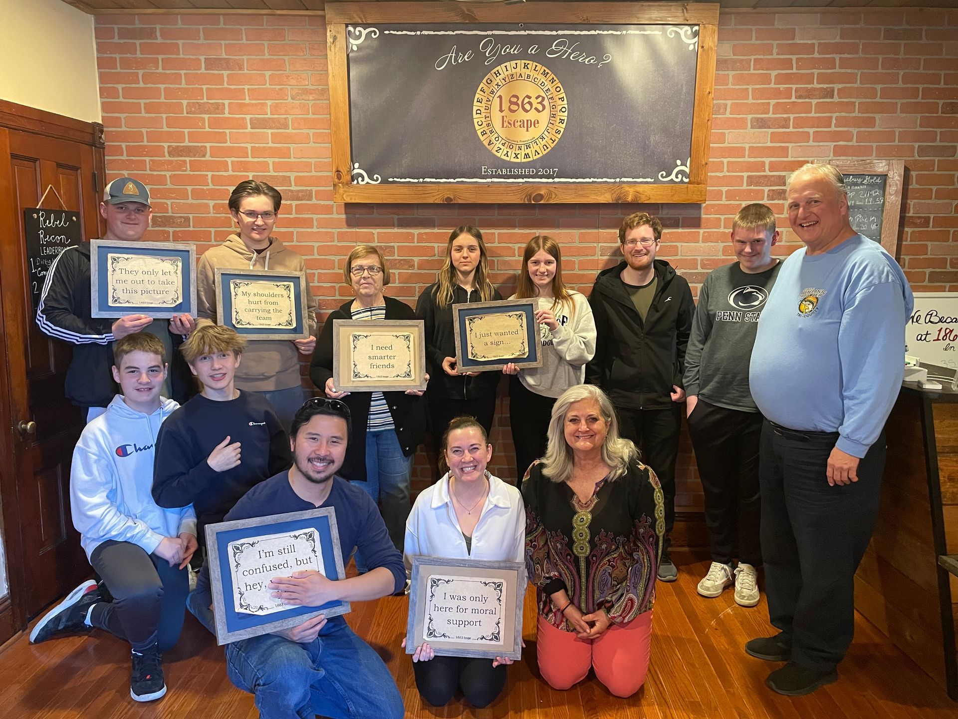 A group of people are posing for a picture while holding plaques
