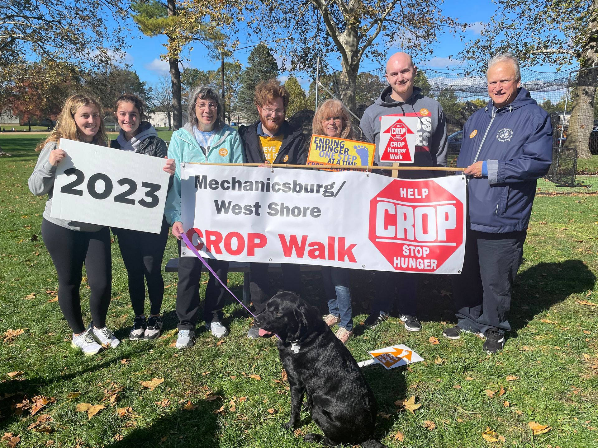 A group of people holding a sign that says crop walk