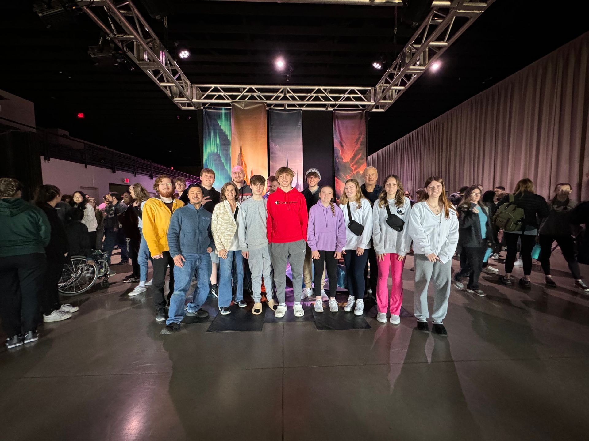 A group of children are posing for a picture in a dark room