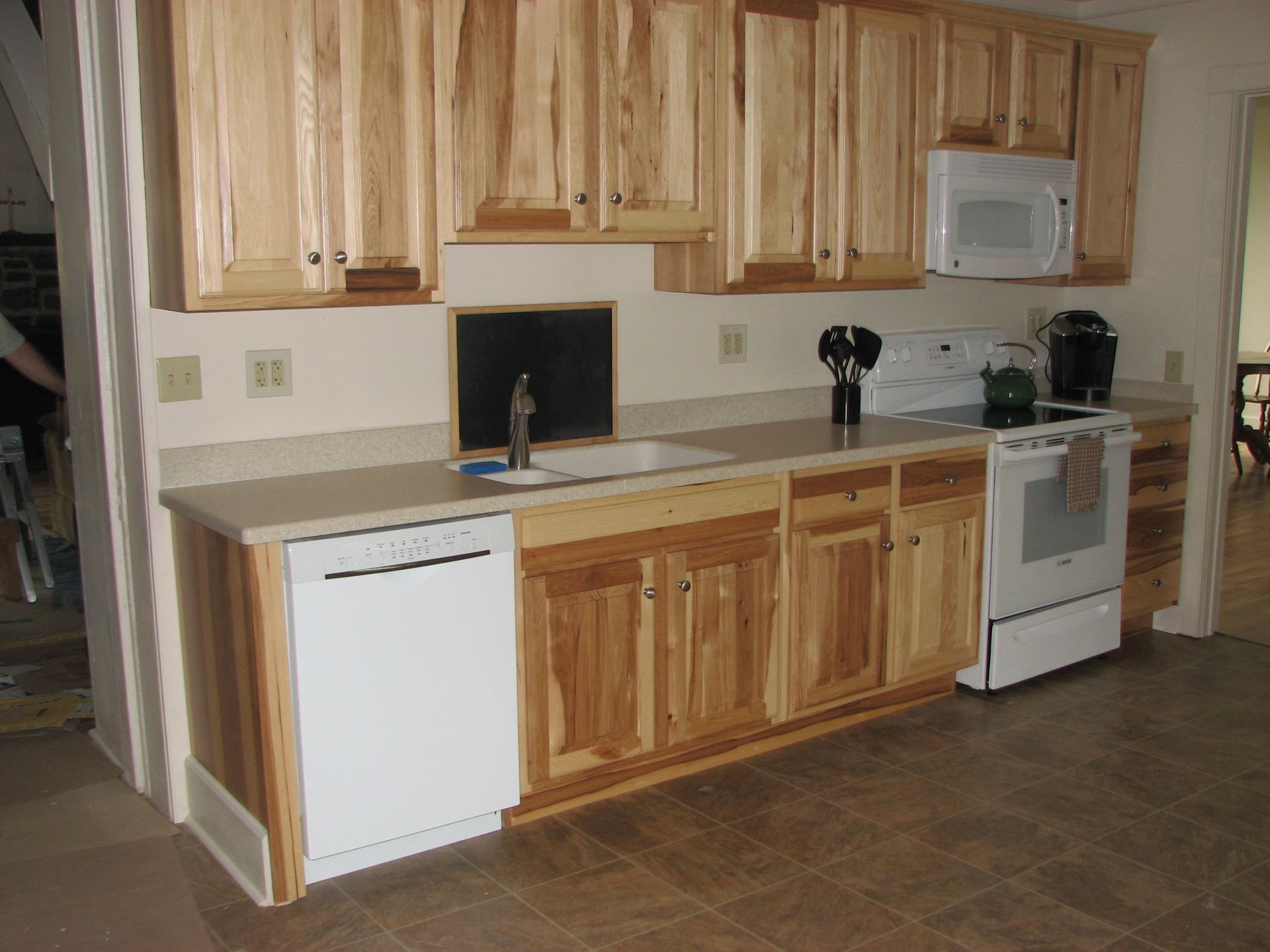 A kitchen with wooden cabinets and white appliances