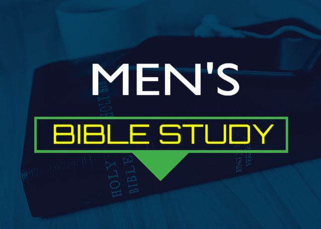 Open Bible with red pen, pencils nearby, illuminated on a wooden surface.