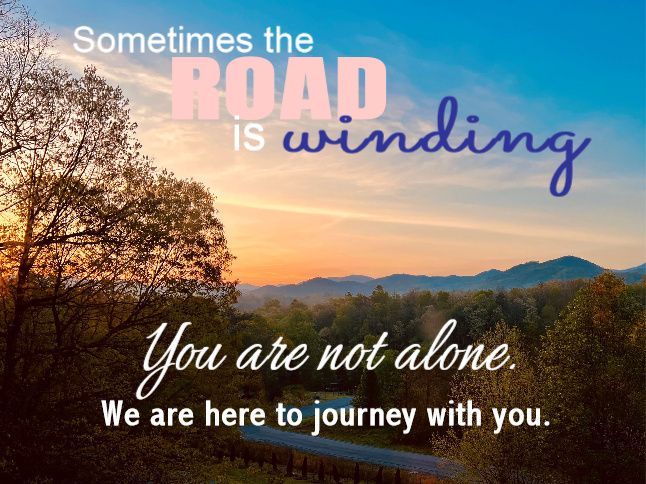 Sunset over a winding road and hills, with text: