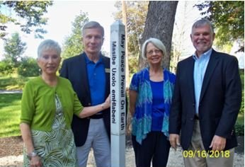 A group of people standing in front of a sign that says 