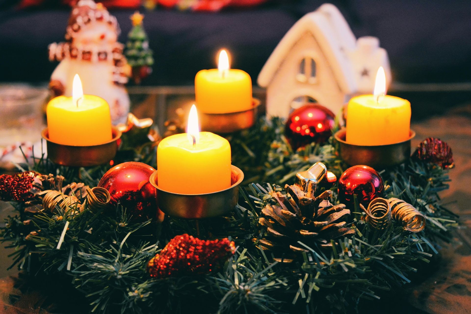 A christmas wreath with four candles on it