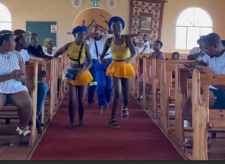 A group of people are dancing in a church.