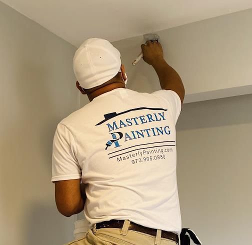 A person is painting a wall with a brush.