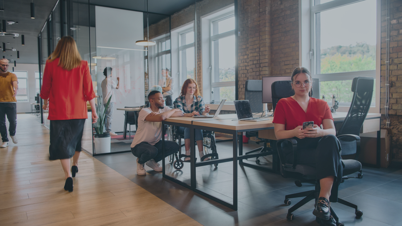 Photo showing diverse group of people working in open plan office furniture trying to reduce stress