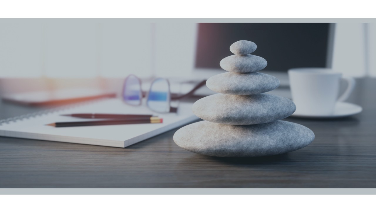 Pebble cairn on a desk.