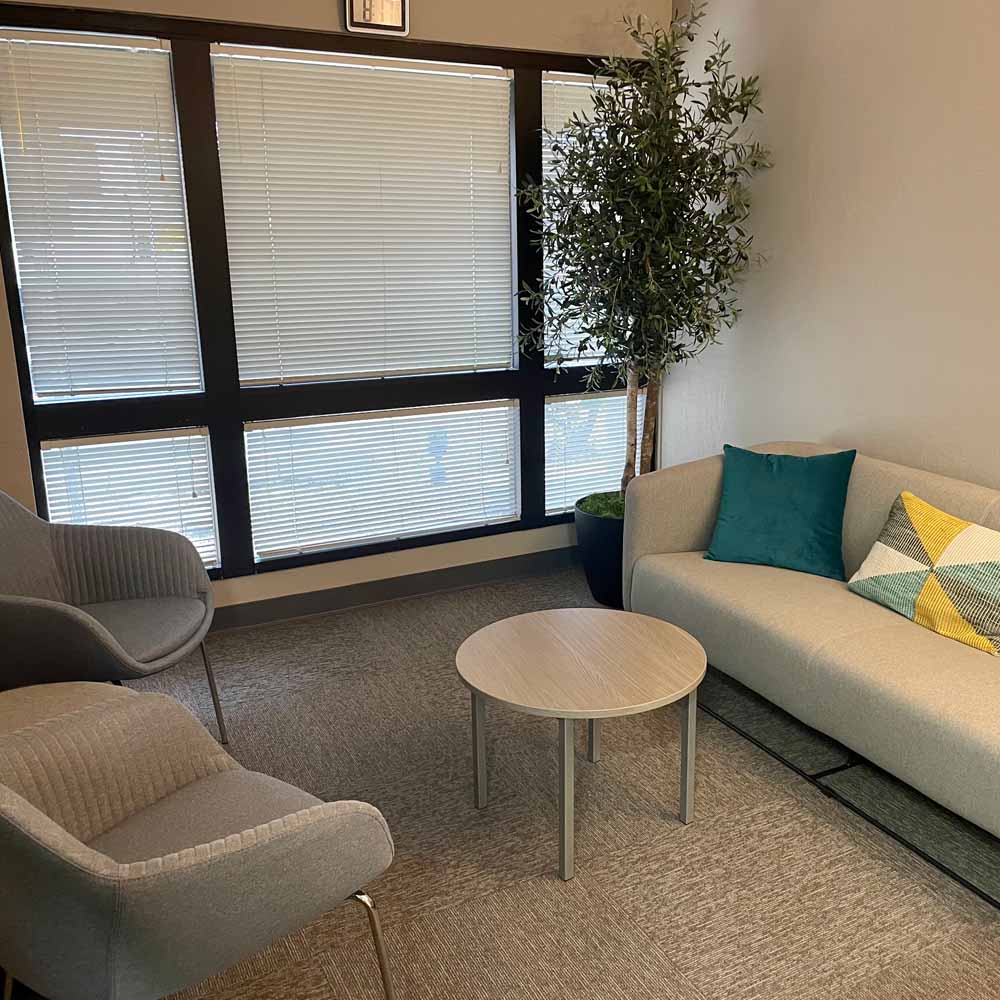 Neutral colored reception area with a potted tree