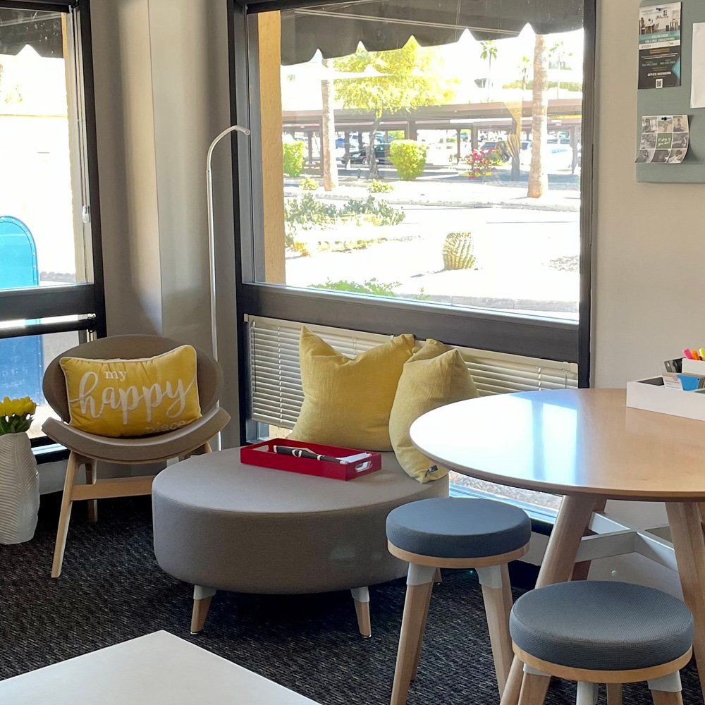 Reception area with comfy seating and yellow accents