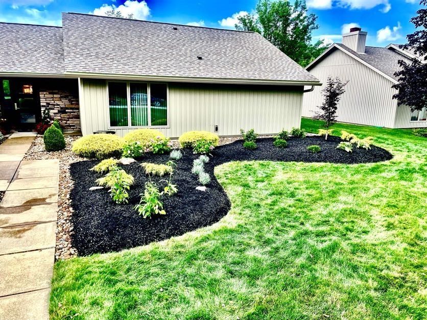 A house with a lush green lawn in front of it