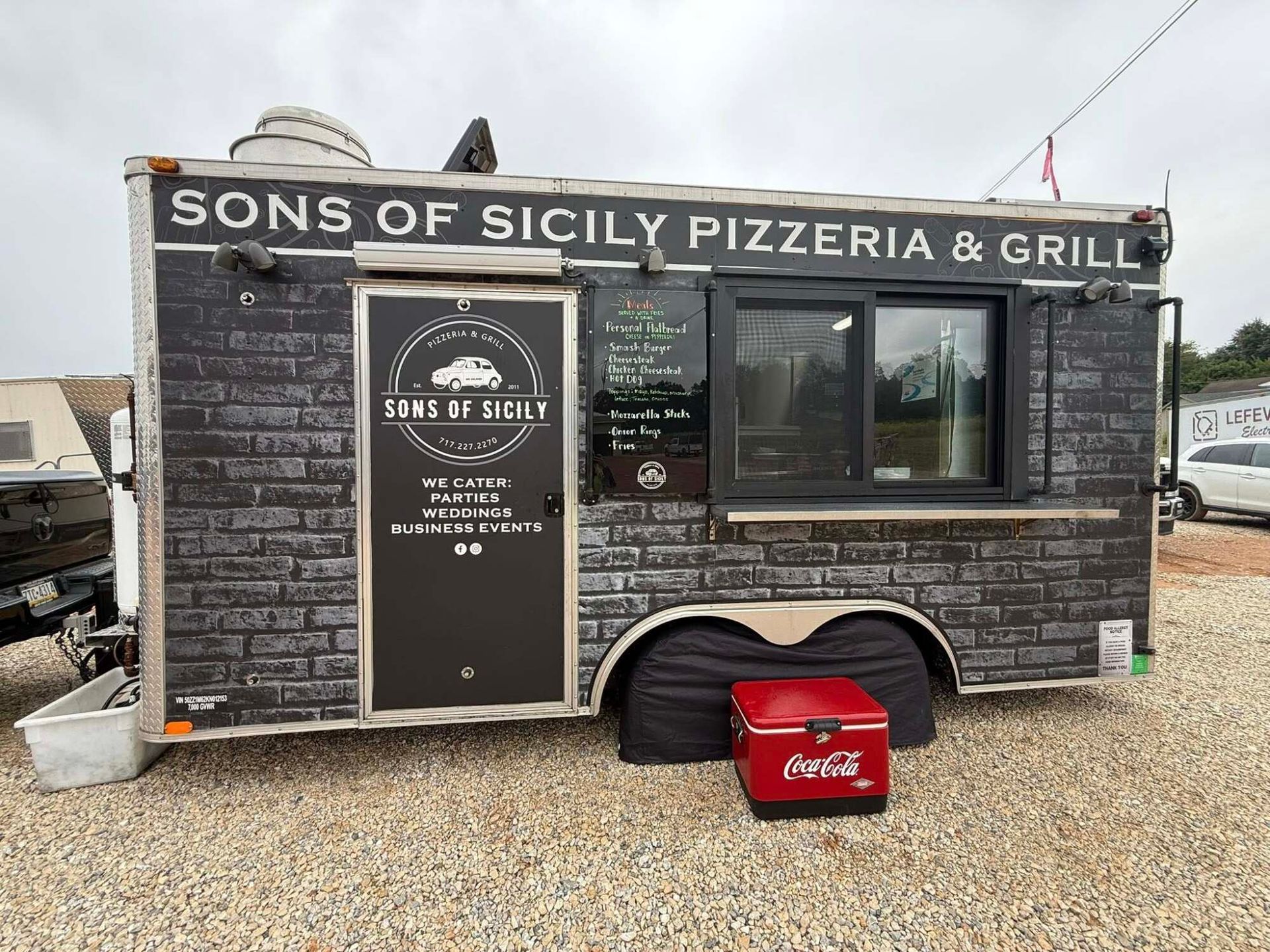 Food truck parked outdoors, providing meals and refreshments during a busy workday