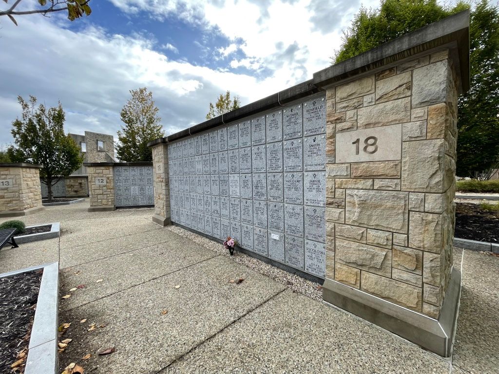 Stone columbarium wall with multiple niches,