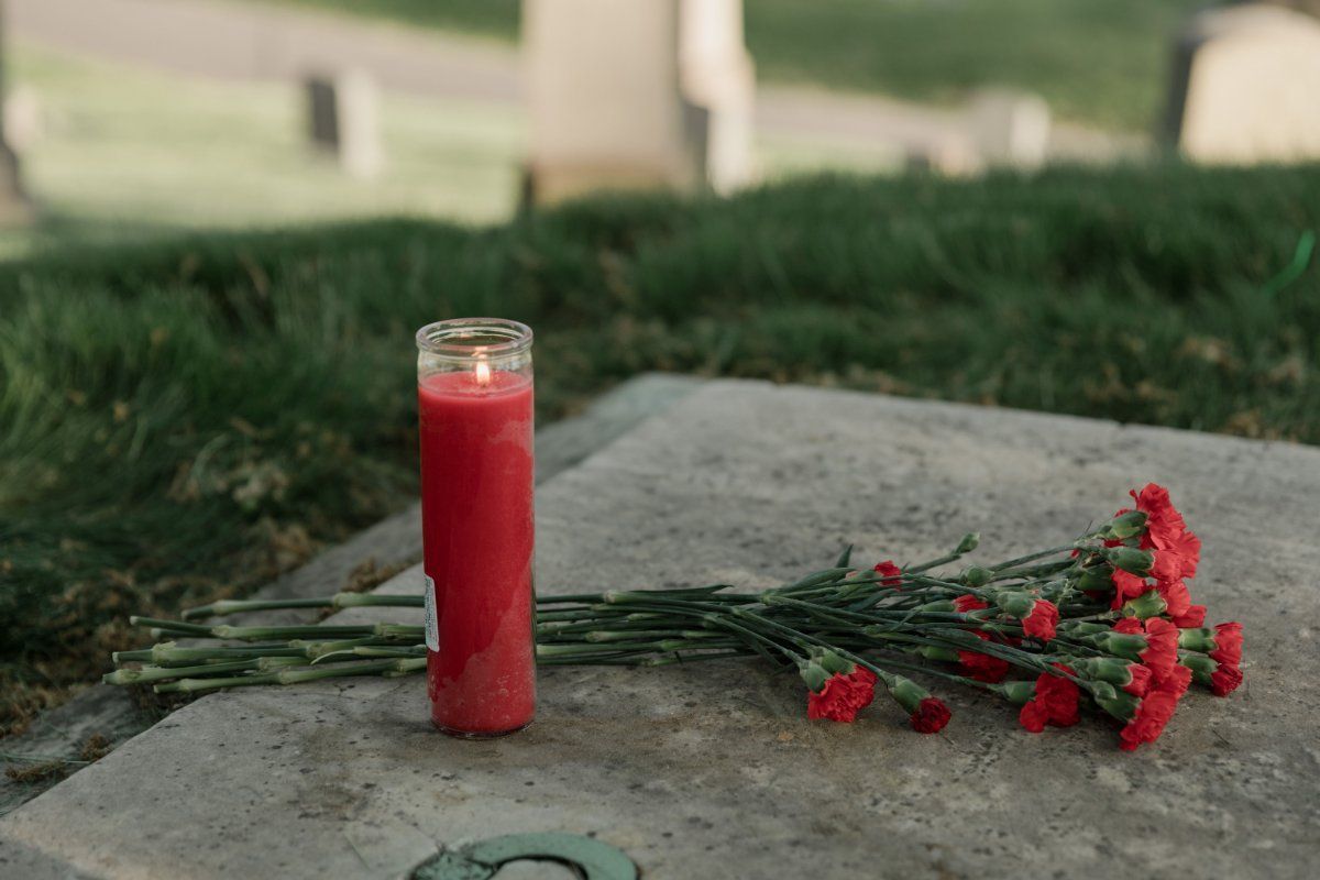 Red flowers and a candle on a tomb at a funeral home in Red Lion, PA