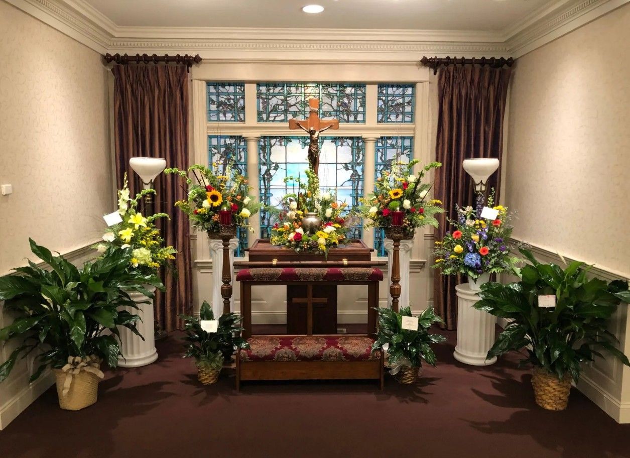 Chapel setup with floral arrangements, and stained glass for Dallastown, PA funeral and cremation services