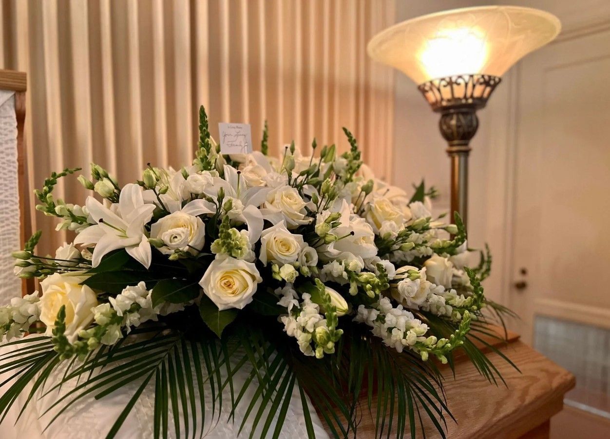 White floral arrangement displayed inside a chapel for Dallastown, PA funeral and cremation services