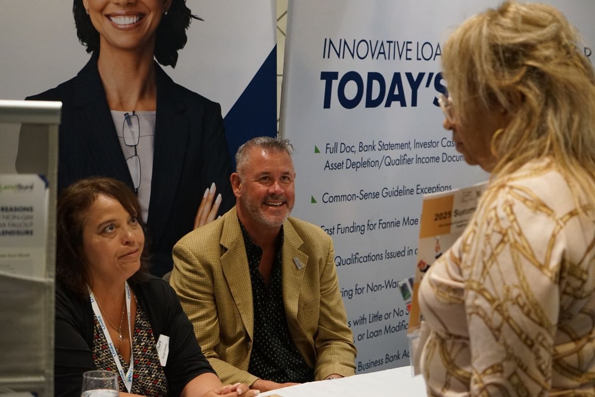 Attendees at an exhibitor table