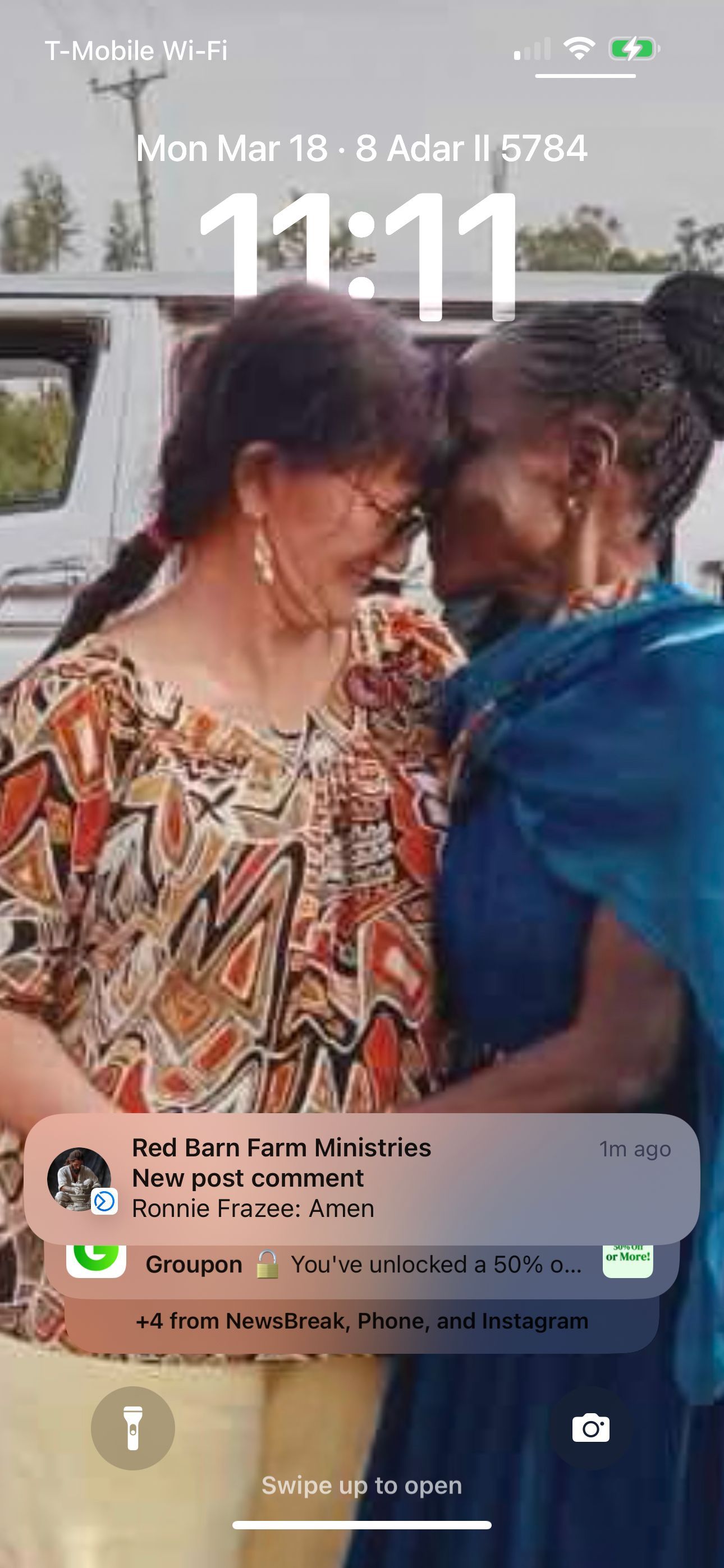 Two women embrace, heads touching