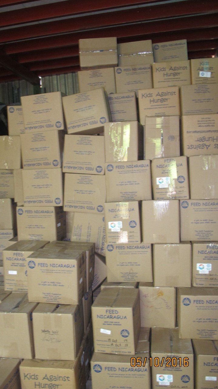 Pile of brown cardboard boxes stacked in a warehouse.