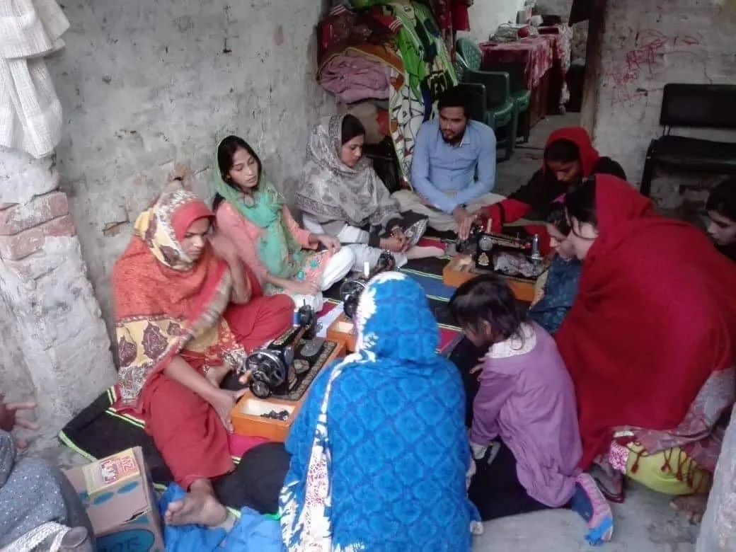 Women Sewing On The Center