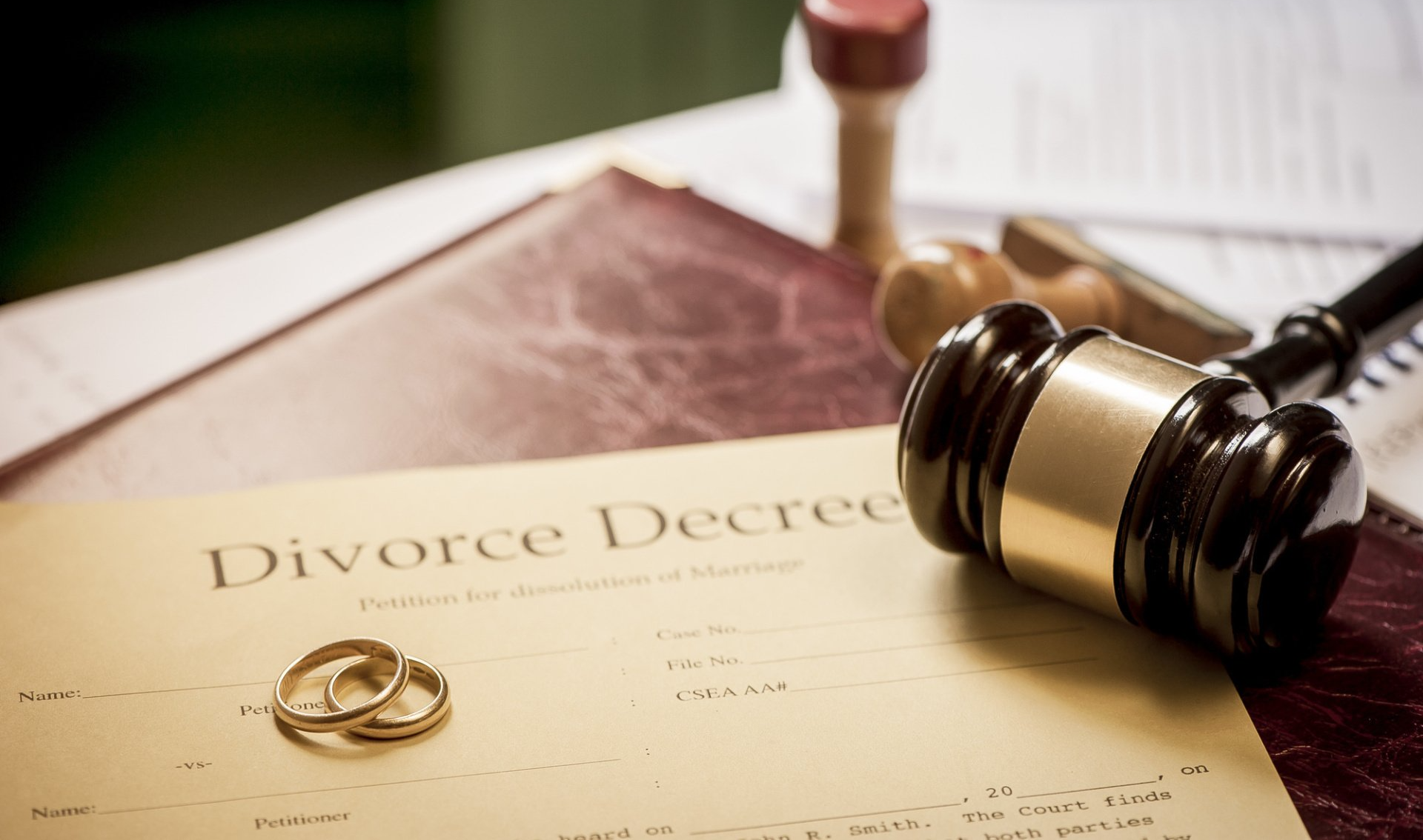 Divorce decree with wedding rings and gavel on a desk