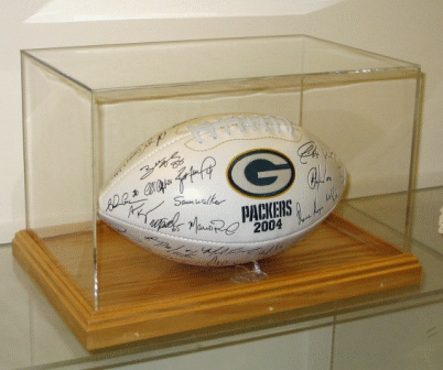 Autographed Green Bay Packers football displayed in a clear case on a wooden base.