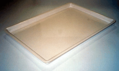 Empty beige rectangular tray with raised edges on a light surface