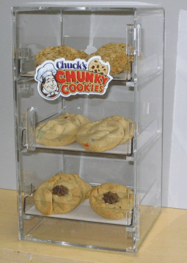 Clear cookie display case with three shelves of chunky cookies and a 