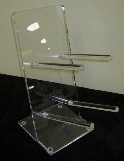 Transparent acrylic brochure holder with multiple horizontal slots on a black surface