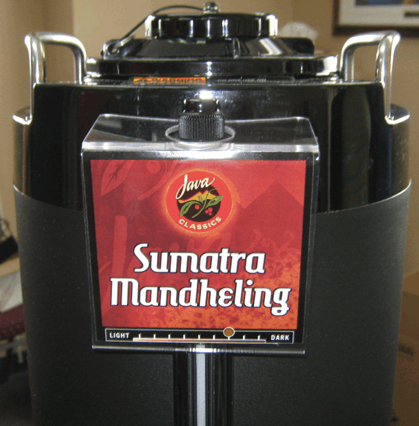 Black coffee dispenser labeled “Sumatra Mandheling” with a red sign on the front