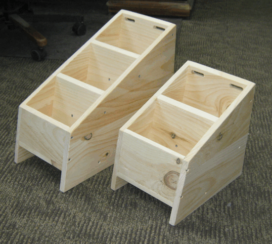 Two unfinished wooden step stools on a carpeted floor