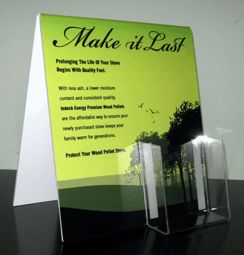 Green brochure titled “Make it Last” beside a clear display stand on a reflective surface.