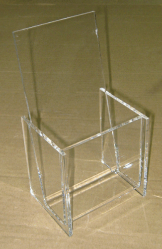 Clear acrylic chair with a tall back against a brown background