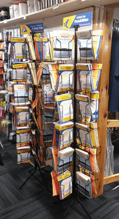 Rotating rack of packaged brochures and flyers in a store aisle