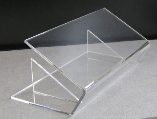 Clear acrylic display stand with two angled panels on a gray surface