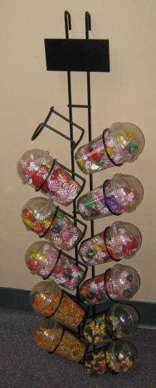 Decorative wire tree holding colorful patterned eggs against a light background