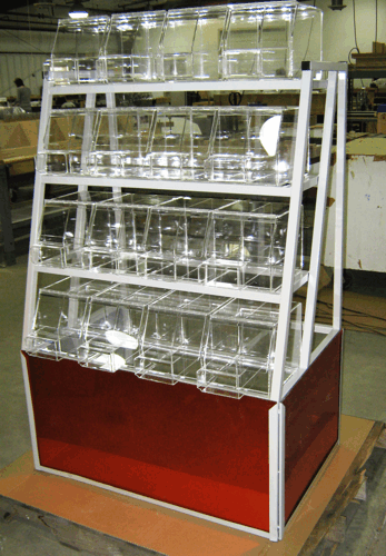 Glassware display case with shelves of clear cups and containers, framed in white with a red base.