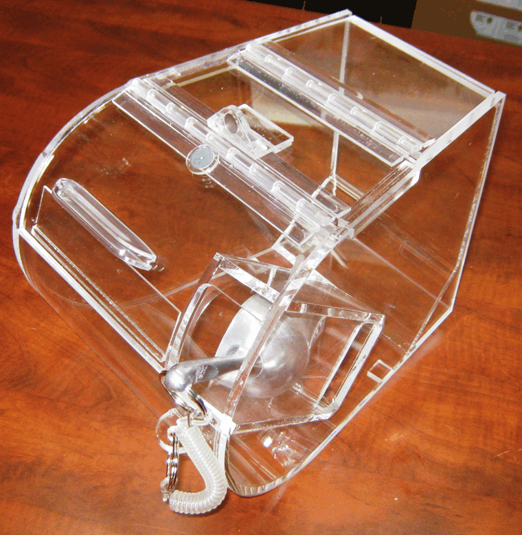 Clear acrylic mouse trap on a wooden table