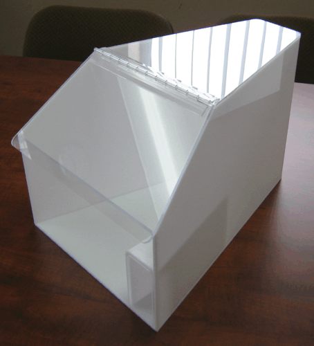 Clear acrylic display box with a slanted front opening on a wooden table