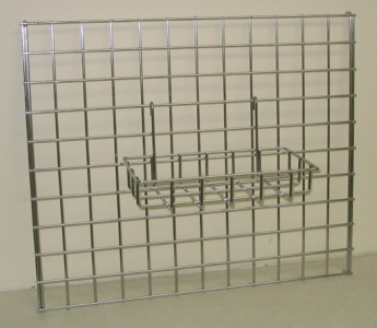 Metal wire grid wall display with a small hanging shelf basket attached in the center