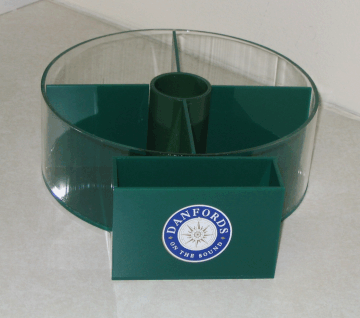 Green plastic desk organizer with circular compartments and a front Penn Foster logo.