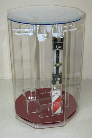 Clear display case with a red base holding stacked Blu and Marlboro cigarette packs