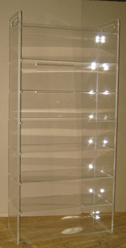 Clear acrylic display case on a wooden surface, with multiple empty shelves and a mirrored back panel.
