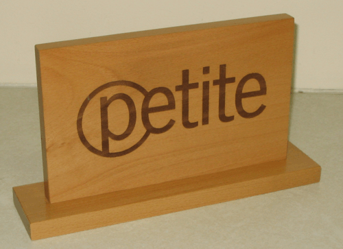 Wooden desk nameplate with the word “petite” engraved on the front