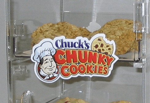 Chuck’s Chunky Cookies logo on a clear display, with two large cookies behind it